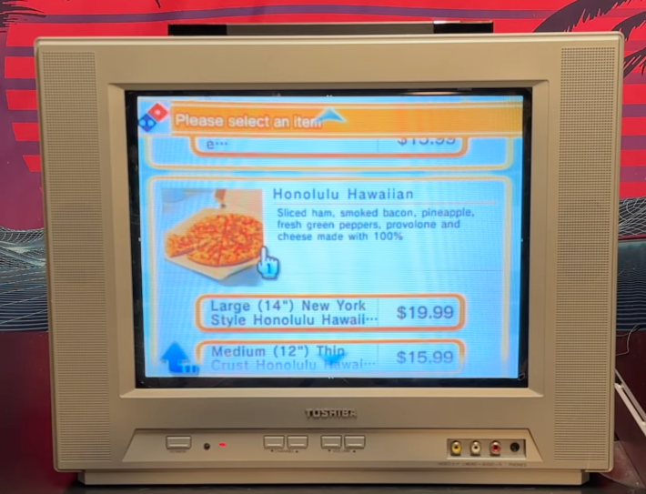 An old tube TV screen with a Dominos pizza menu featuring Hawaiian pizza.