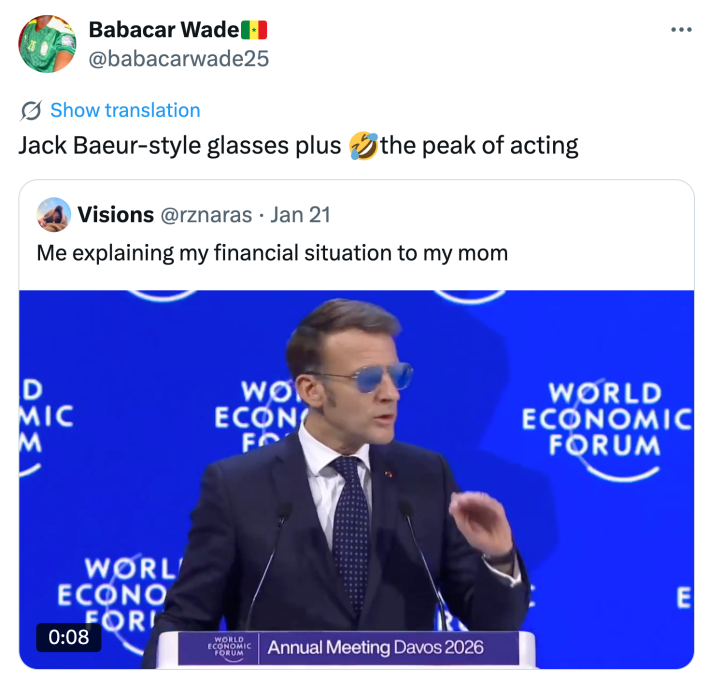 Tweet that reads, "Jack Baeur-style glasses plus 🤣the peak of acting" with a video of Macron giving a speech at the World Economic Forum.