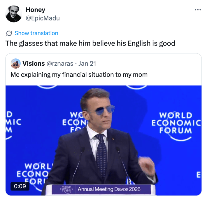 Tweet that reads, "The glasses that make him believe his English is good" with a video of Macron giving a speech at the World Economic Forum.