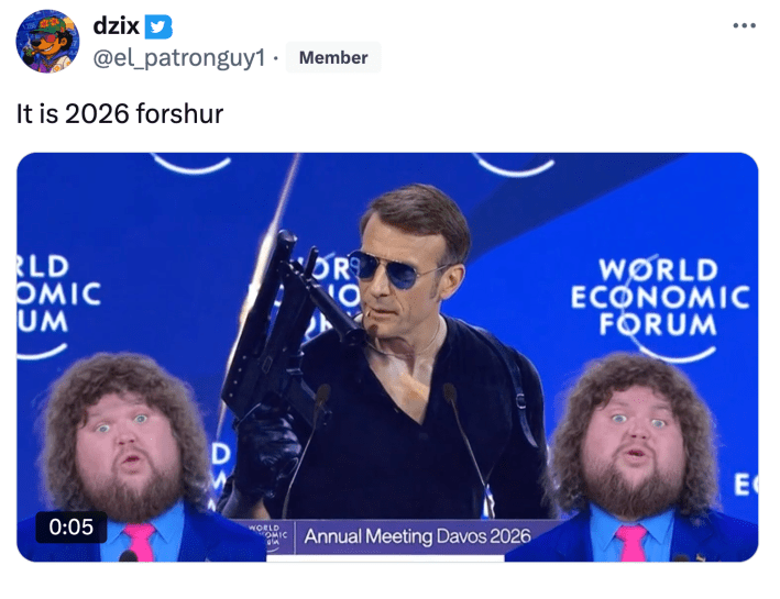 Tweet that reads, "It is 2026 forshur" with an AI-edited video of Macron giving a speech at the World Economic Forum but he's wearing a black shirt, gloves, and is holding a gun. Two overweight JD Vance meme characters are singing in the bottom corners of the video.