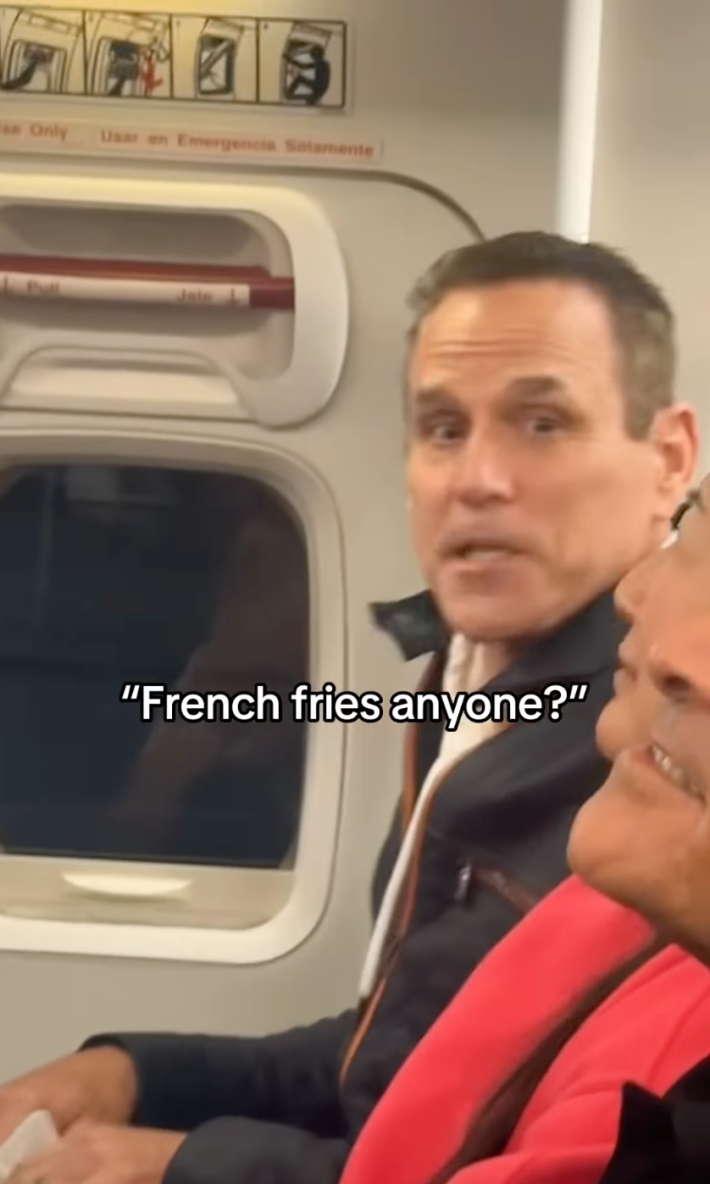 A man in an exit row seat asking, "French fries, anyone?" after they were thrown in his face by an angry passenger.