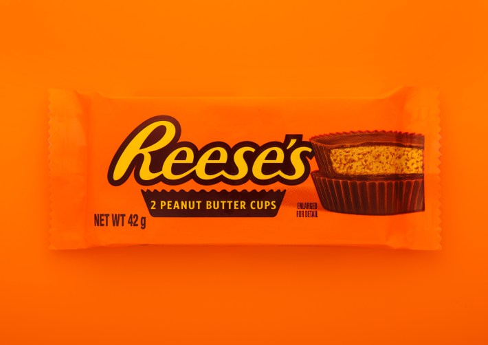 Reese's peanut butter cups snack on orange background