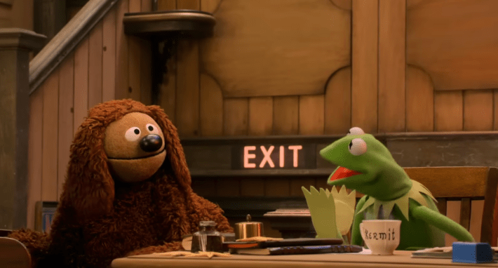 rolf and kermit at a desk