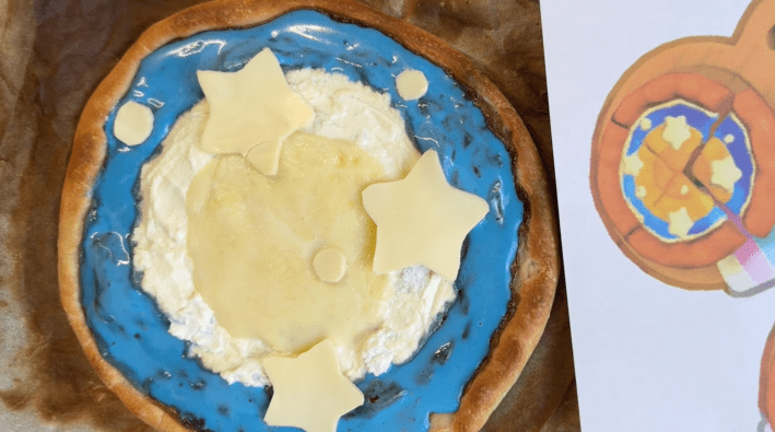 pizza with blue sauce and cheese stars