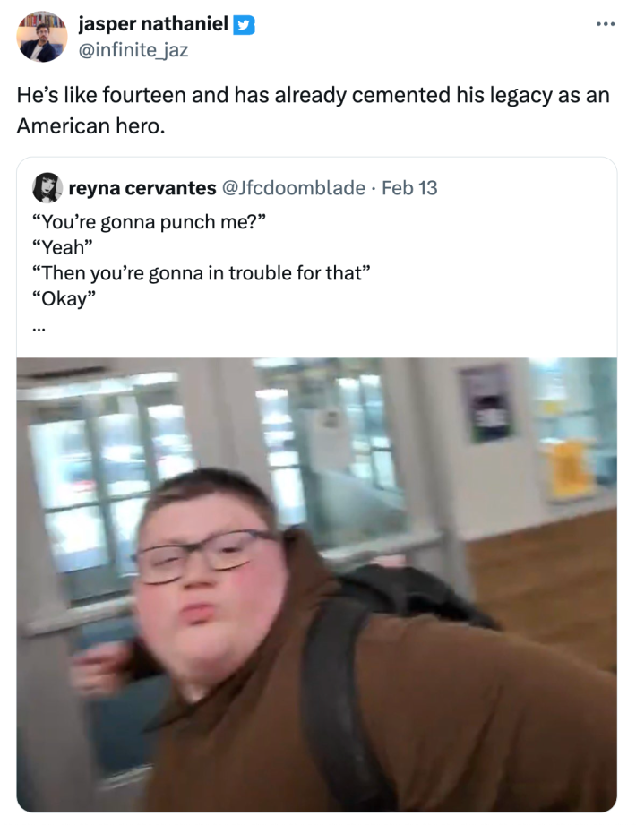 Brown hoodie kid punching meme. text reads, "He’s like fourteen and has already cemented his legacy as an American hero."