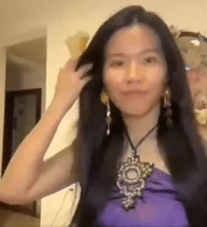 The woman with long hair and a purple halter top, this time without the filter.