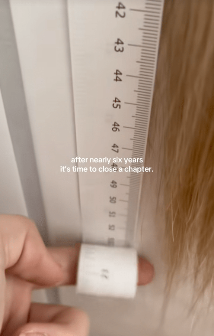 @reallyrapunzel/TikTok measuring over 50 inches of hair with onscreen text "after nearly six years it's time to close a chapter."