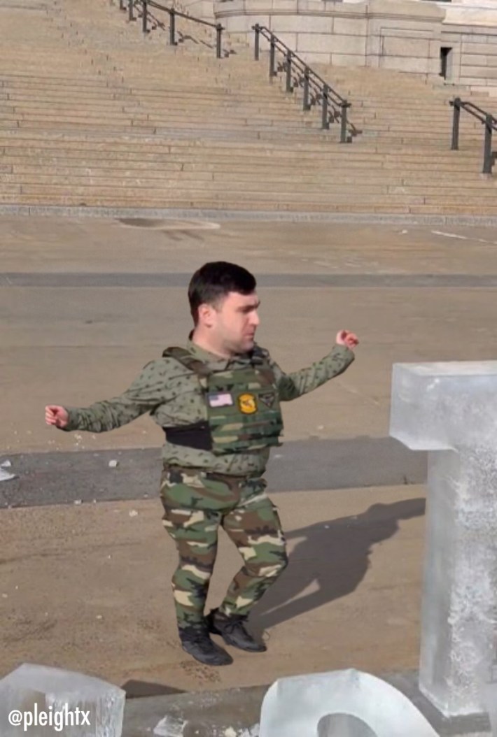 Screenshot of Jake Lang damaging the "Prosecute ICE" sculpture edited to make him look very short.