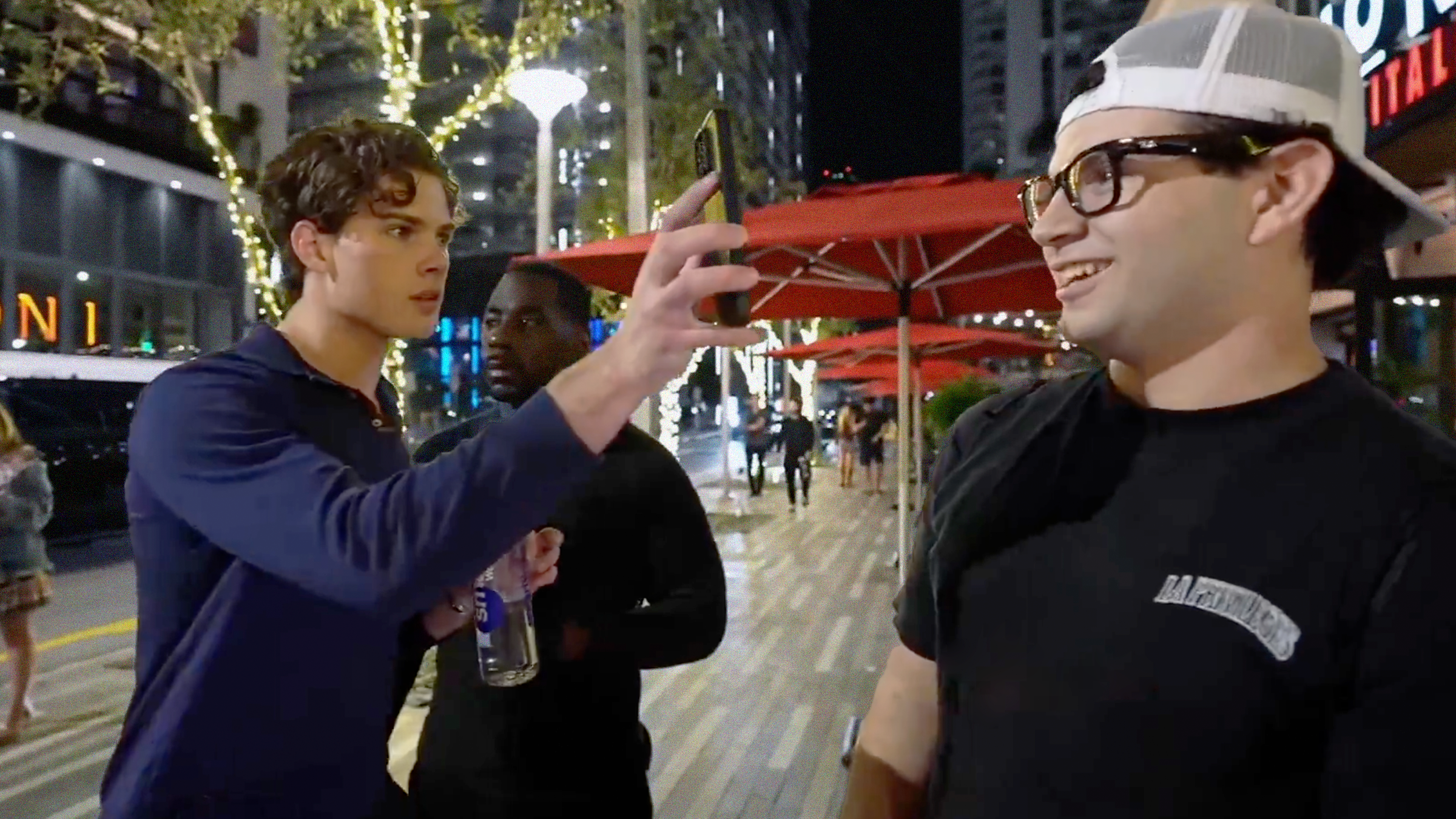 Streamer Clavicular puts a phone to a man wearing Meta glasses's face