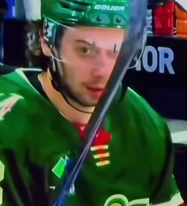 Quinn Hughes disassociating and staring off into space while on the bench.