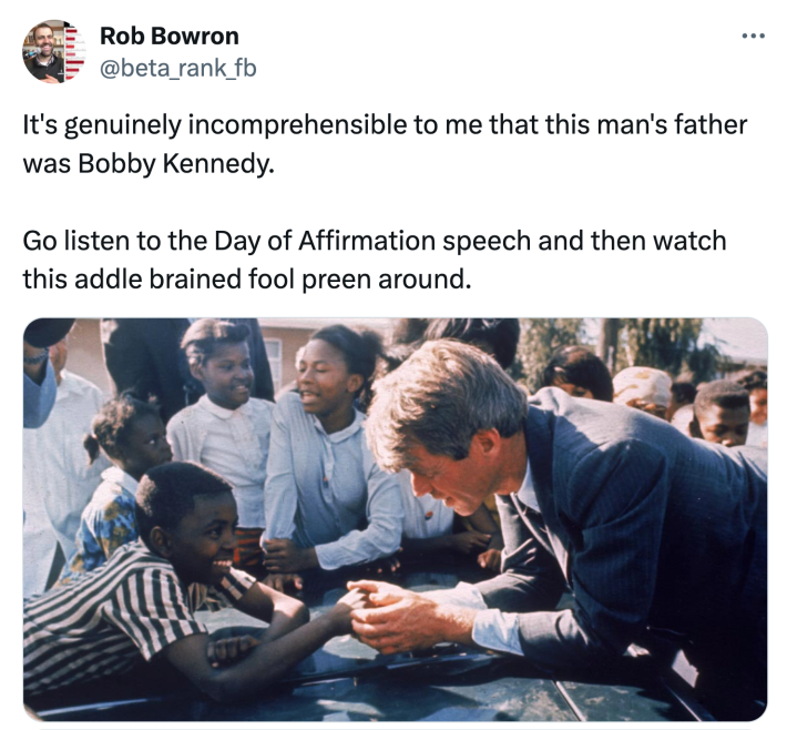 Tweet that reads, "It's genuinely incomprehensible to me that this man's father was Bobby Kennedy.Go listen to the Day of Affirmation speech and then watch this addle brained fool preen around." with a photo of Bobby Kennedy with a group of young Black students.