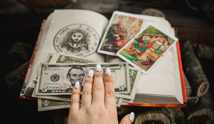 book with money and tarot cards