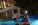Streamer Clavicular leaning towards a woman in the dark by a pool and mansion, text overlay reads, "You're like by yourself maxxing."