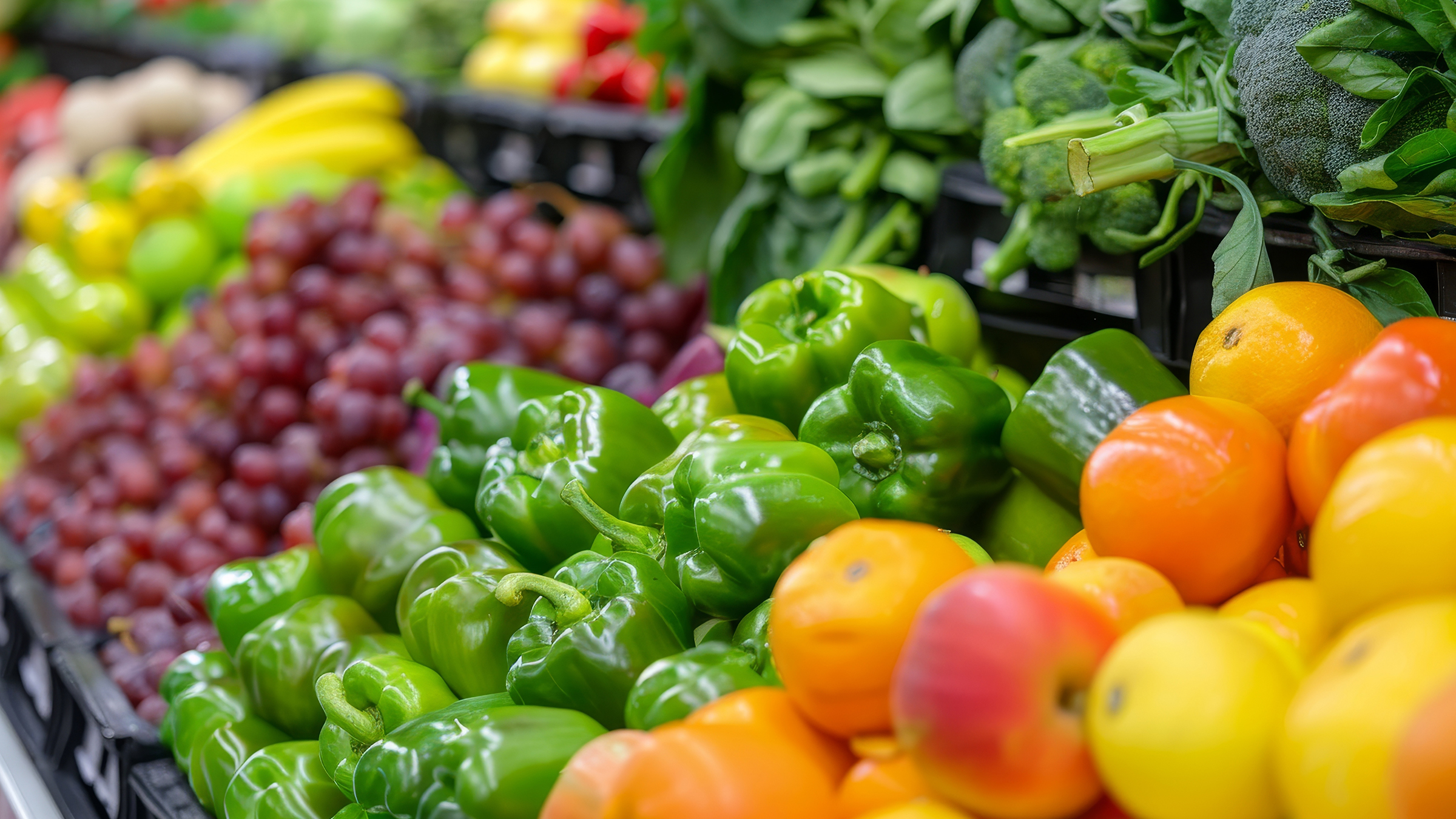 Colorful fruits and vegetables in the produce section of the grocery store.