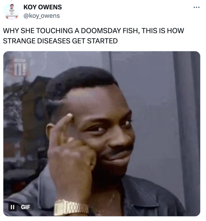 Tweet that reads, "WHY SHE TOUCHING A DOOMSDAY FISH, THIS IS HOW STRANGE DISEASES GET STARTED."