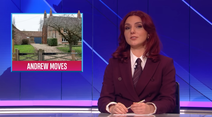 A woman in a maroon suit with red hair speaking in a news-style segment. The title card on screen shows a large "cottage" with a fence and text reads, "Andrew Moves."