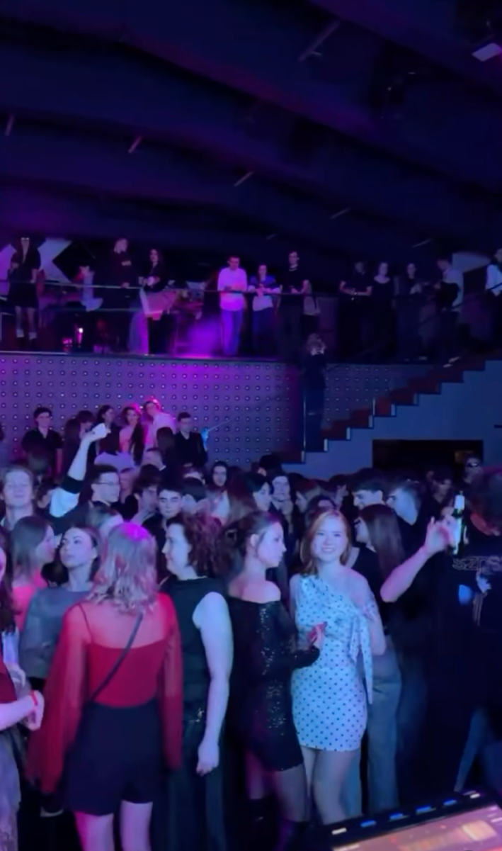 A crowd of people partying in a Russian night club.