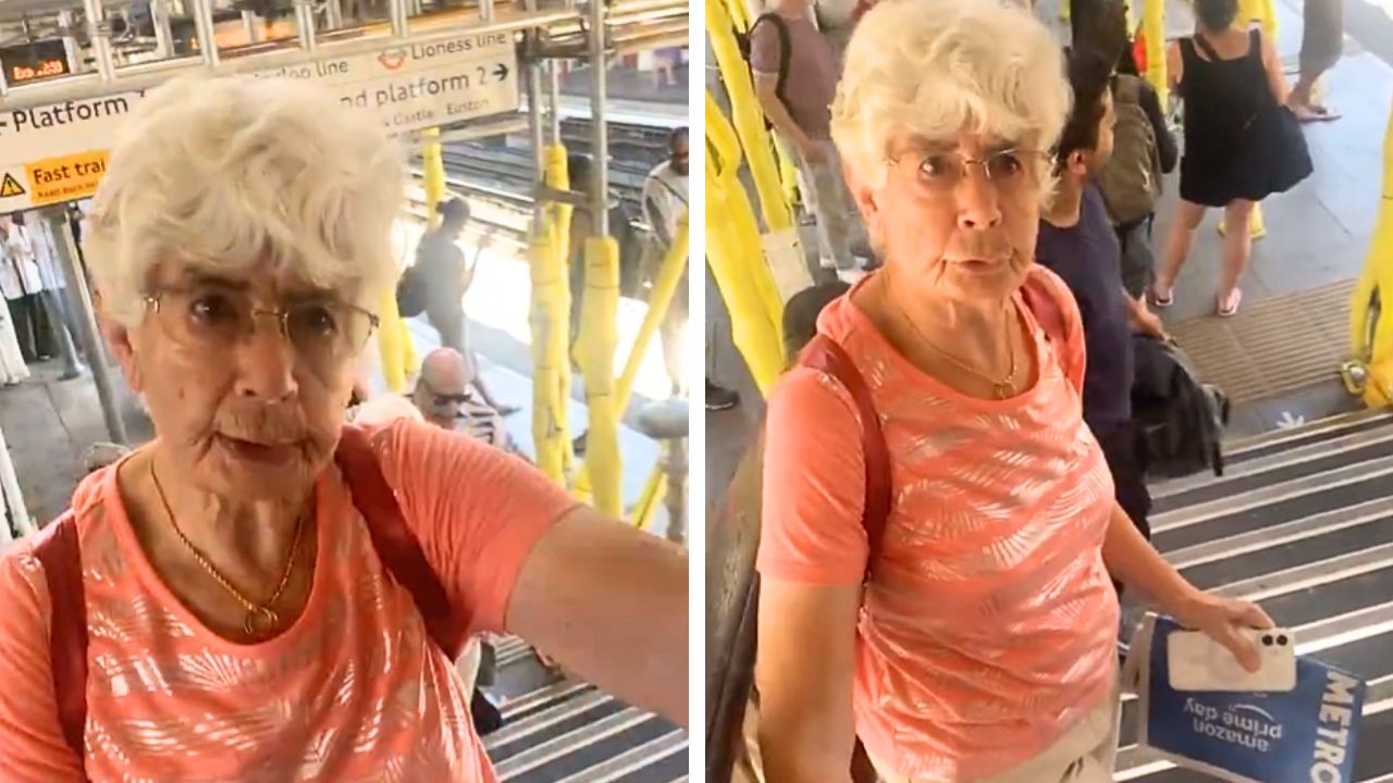 A man blocks an elderly woman on the train station stairs