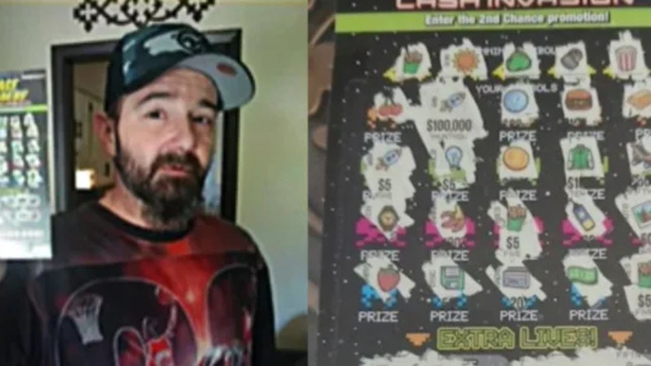 Man holds winning lottery ticket.