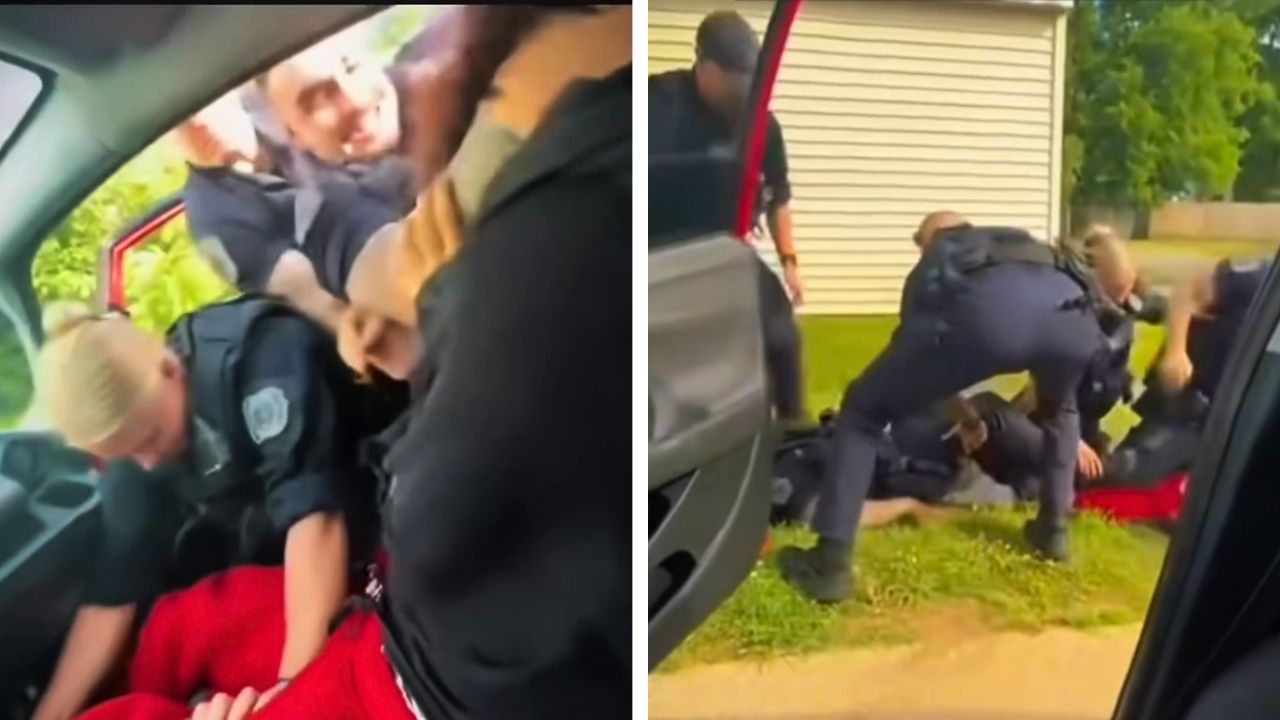 Police officers forcibly remove a passenger from a vehicle