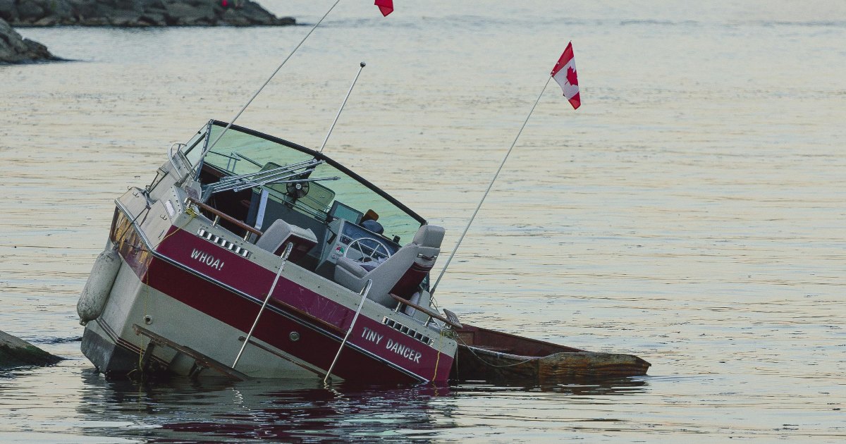 Small boat sinking in the water.