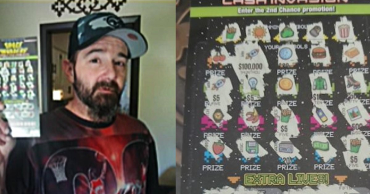 Man holds winning lottery ticket.
