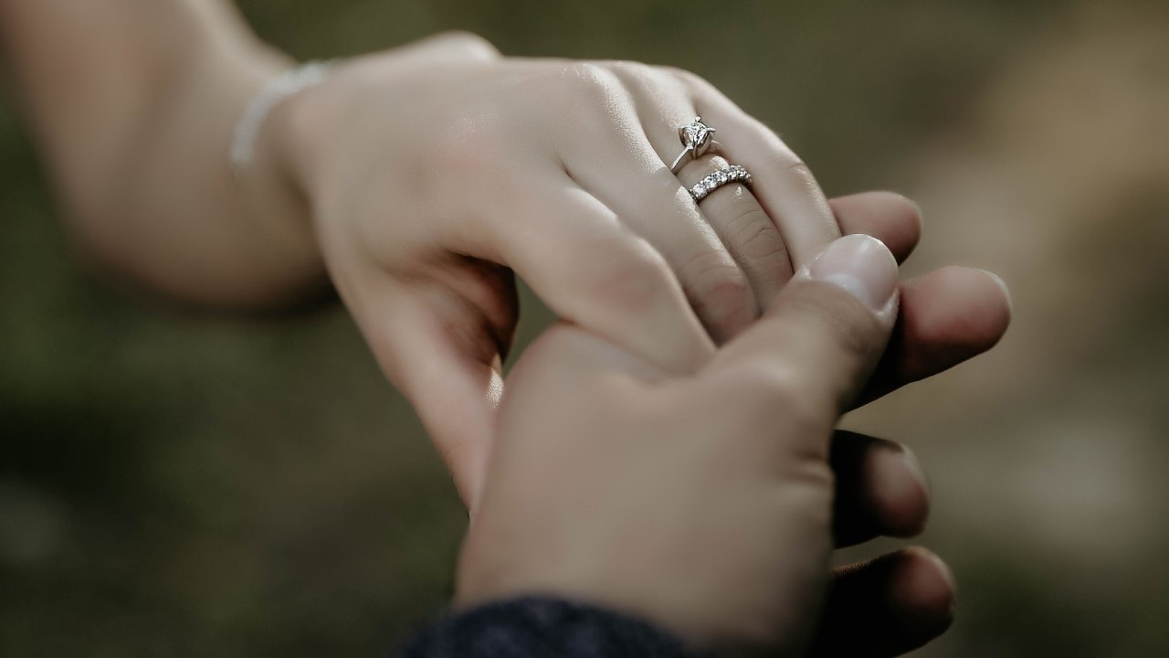 A man and woman holding hands on wedding day.