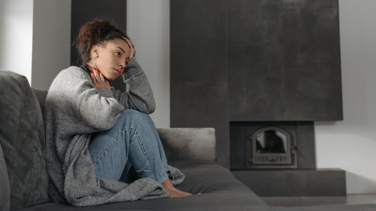 Woman sitting alone in a home setting