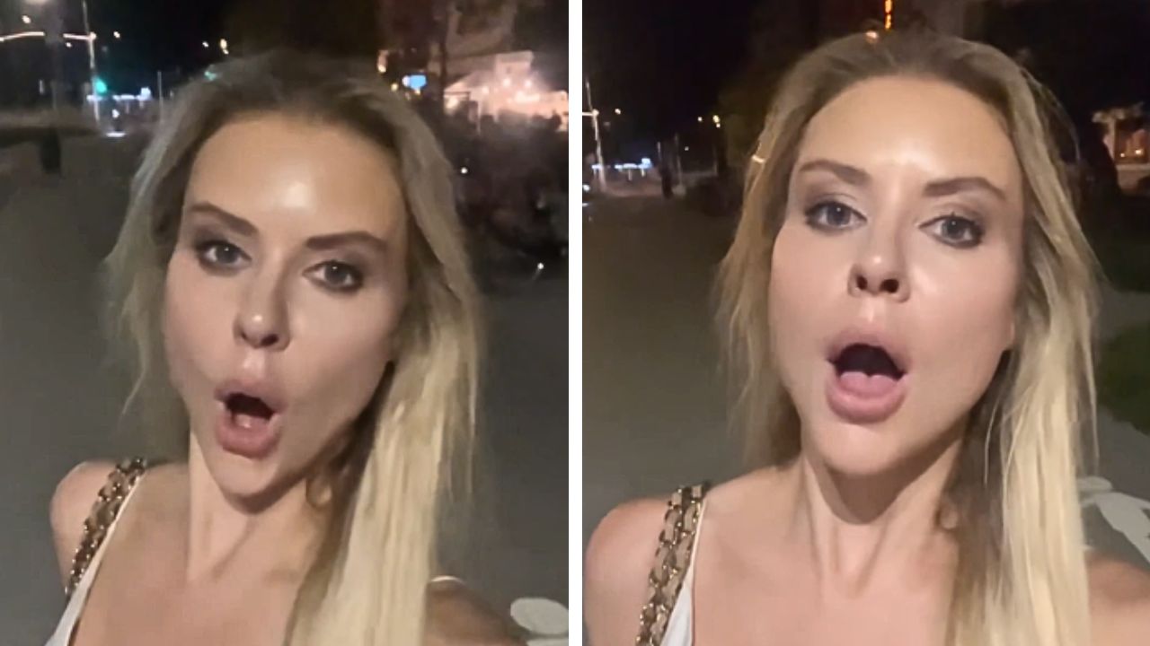 A woman walks alone along a Warsaw street at night in a video about safety in Poland.