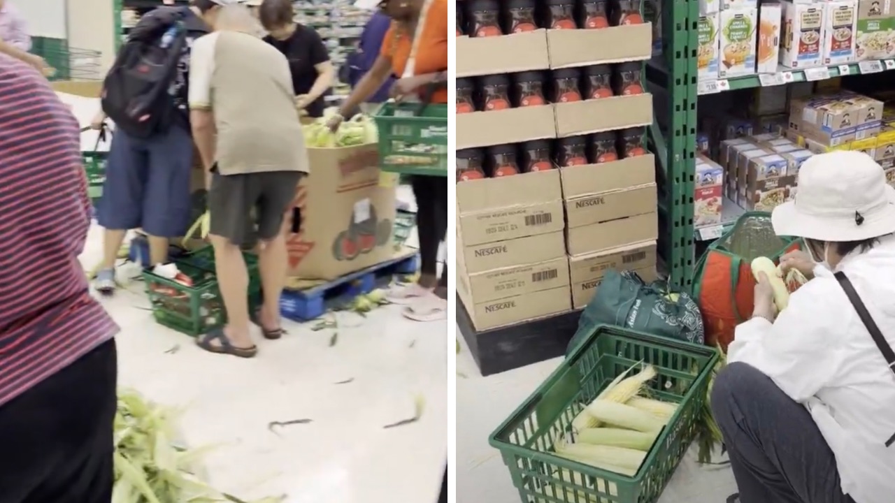 Shoppers husking corn in grocery store