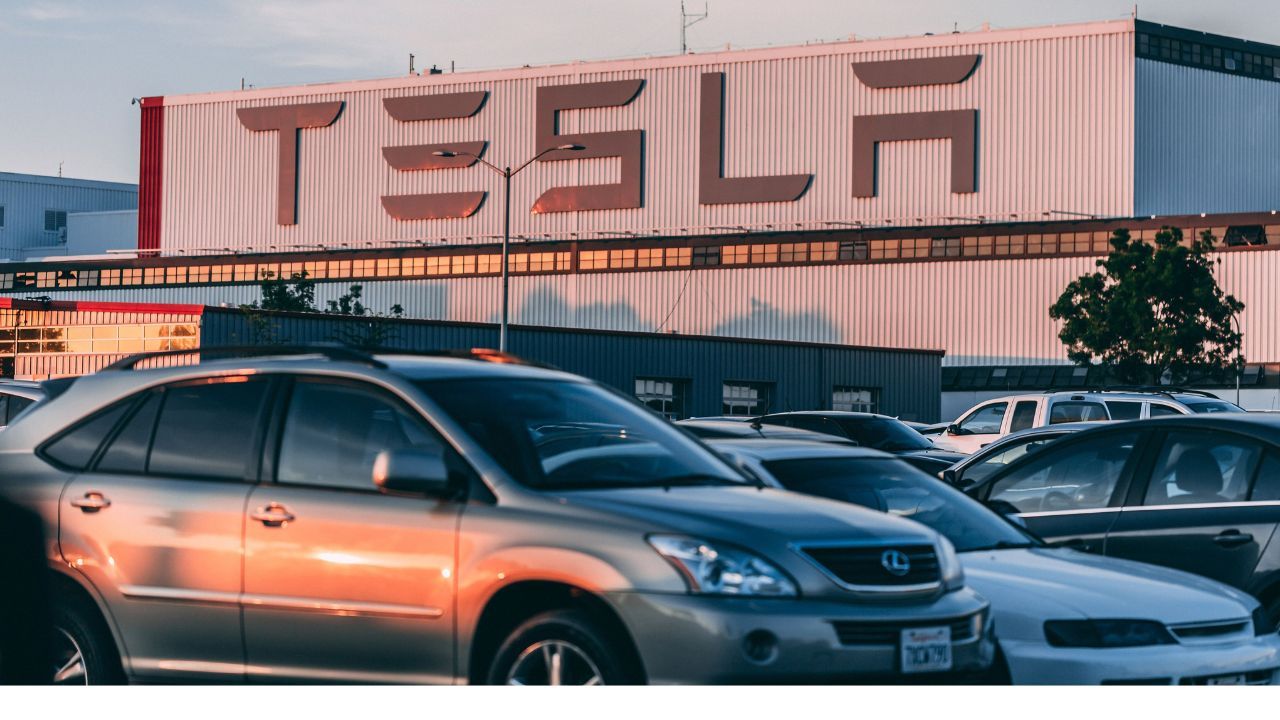 Bystanders restrain a driver during a reported stolen Tesla incident on a California boardwalk.