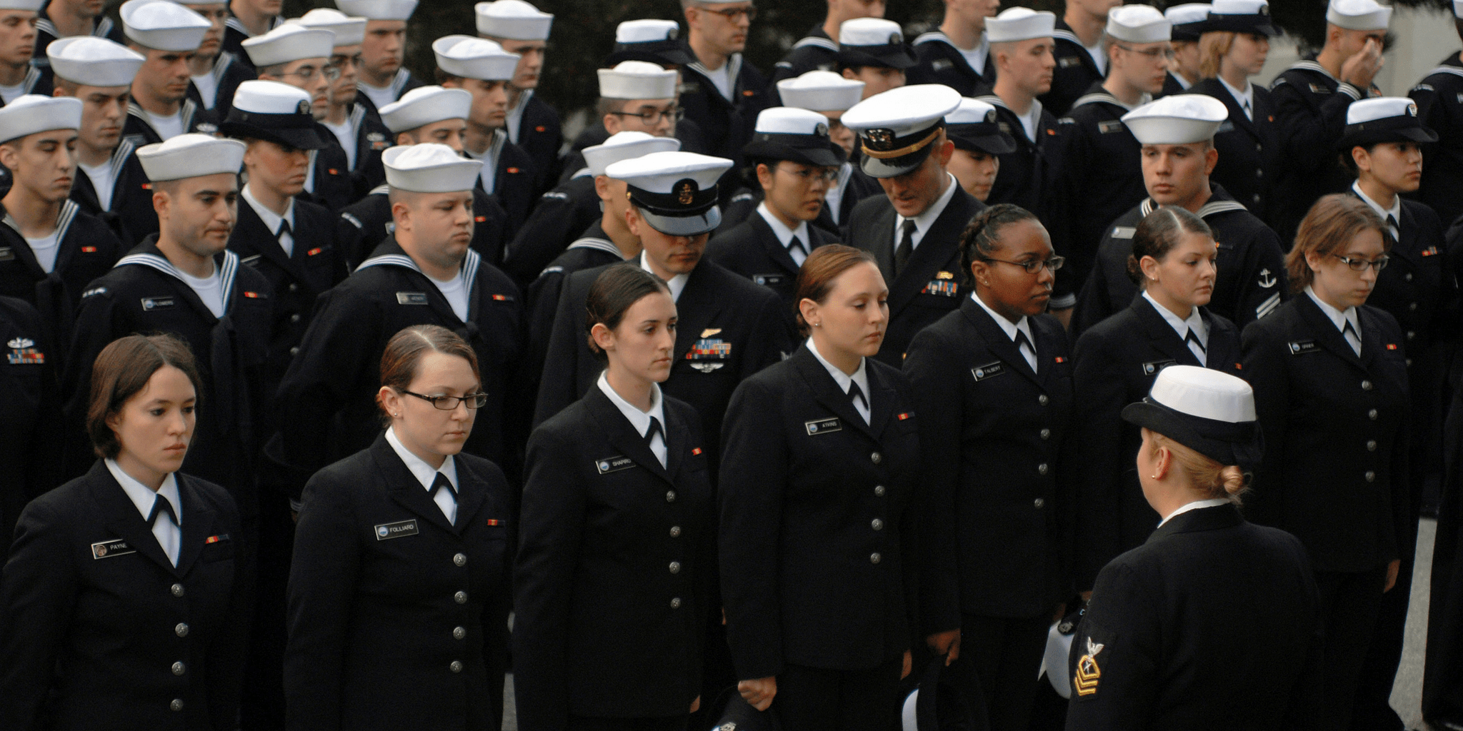 Navy personnel inspect the hairstyles of female Sailors during a personnel inspection at the Presidio of Monterey