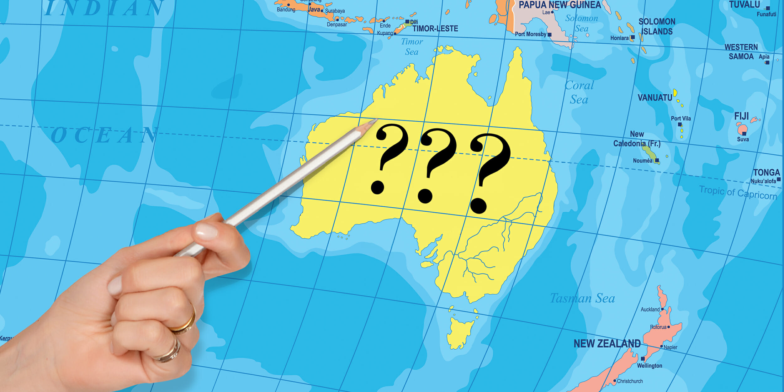 Hand pointing pencil to Australian continent labeled "???"