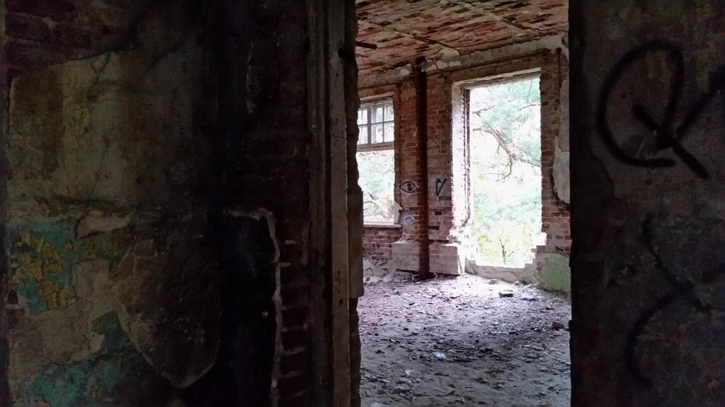 Inside the doorway, the far pillar displays the most significant markings left by the puzzle creators. 