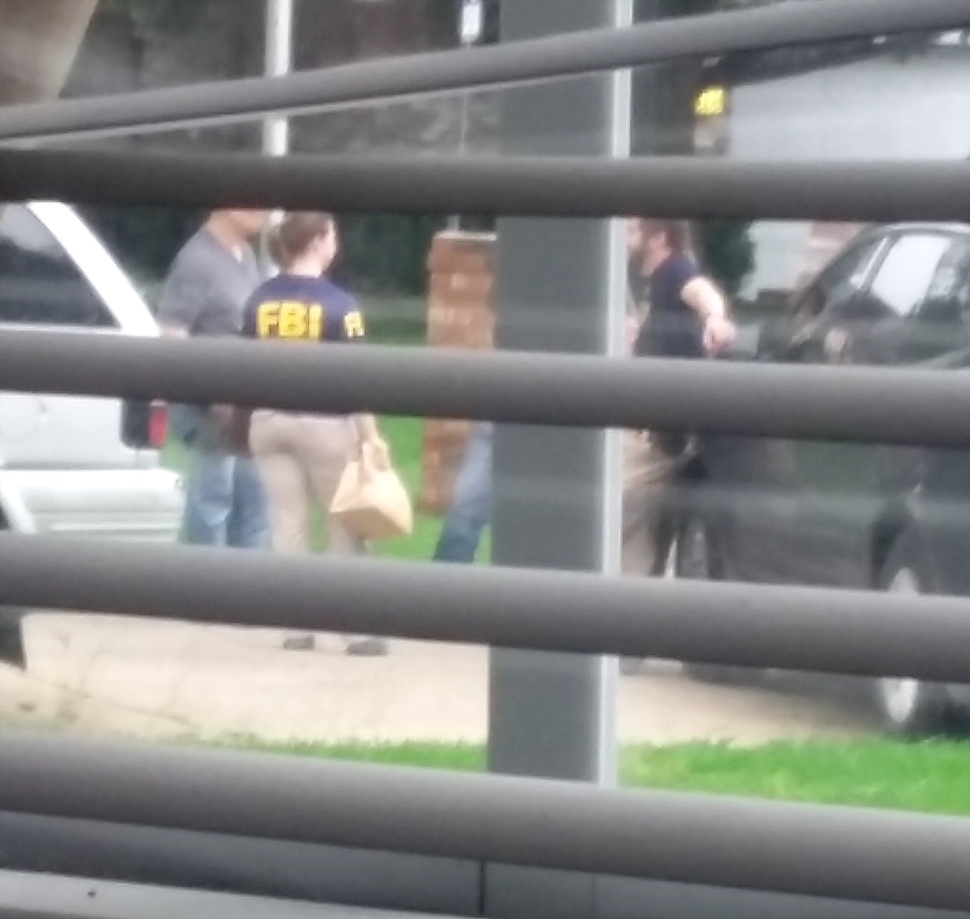 8:30am, FBI agents outside Shafer’s home, as seen through a neighbor’s window.